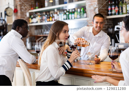 Two women sitting at the bar 129811280