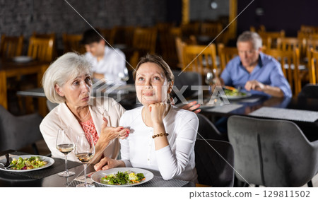 Sad young woman share with friend about difficulties of interpersonal communication in teamwork. Sad young woman share with friend about difficulties of interpersonal communication in teamwork. 129811502