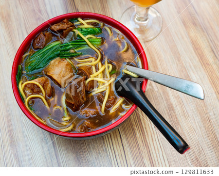 Bowl of ramen with wheat noodles, veal, mushrooms, chard Bowl of ramen with wheat noodles, veal, mushrooms, chard 129811633