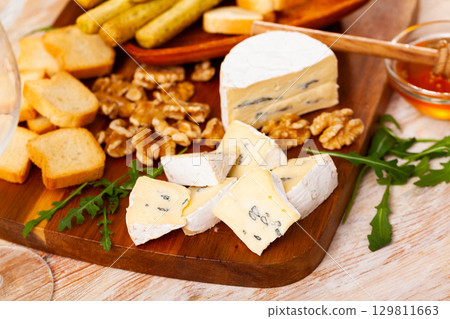 Blue cheese served with croutons and walnuts Blue cheese served with croutons and walnuts 129811663