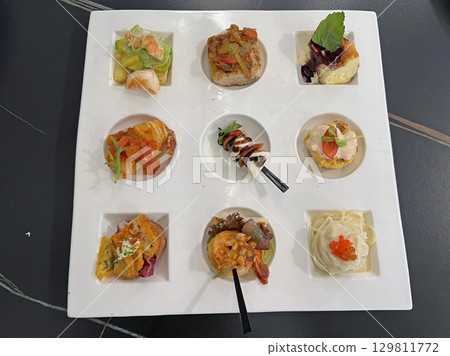 Take a close-up photo of the exquisite nine-square afternoon tea in the restaurant Take a close-up photo of the exquisite nine-square afternoon tea in the restaurant 129811772