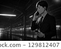 晚上，一名西裝革履的男子在月台上戴著耳機講話 129812407