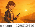 一名女子沿著月台行走，用智慧型手機查看自己的行程。 129812410