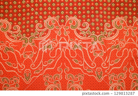 Elegant textile details of orange batik pattern Indonesia  129813287
