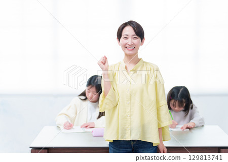 A girl studying and her mother giving a thumbs up A girl studying and her mother giving a thumbs up 129813741