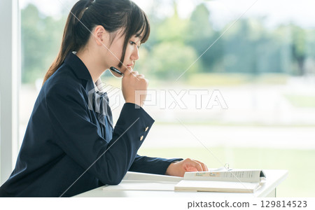 Elementary school, junior high school, and high school girls in uniforms taking classes in the classroom 129814523