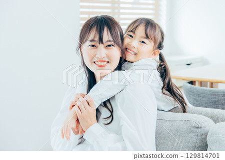 A young family relaxing in the living room A young family relaxing in the living room 129814701