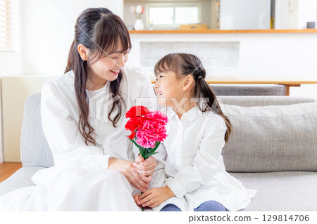 Girl handing a bouquet of carnations 129814706