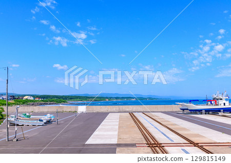 Otosibe area of Okhotsk Esashi Fishing Port and the coast, with a June blue sky 129815149