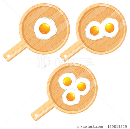 Fried Eggs in Wooden Frying Pans Top View 129815229