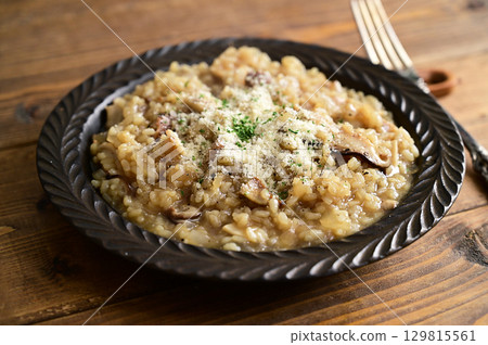 Mushroom risotto with ajillo oil 129815561