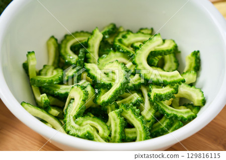 Cut bitter melon in a bowl | Cooking process and preparation image 129816115
