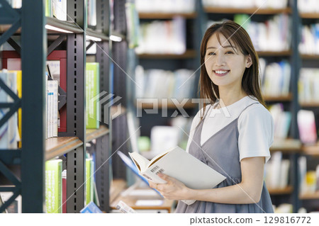 尋找一本書在圖書館裡的年輕女子 129816772