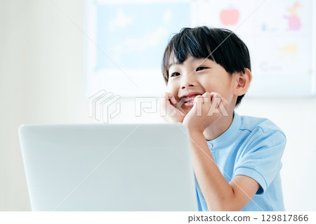 A boy taking a class in front of a computer A boy taking a class in front of a computer 129817866