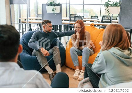 Woman needs help. Group of people are having therapy meeting together 129817992