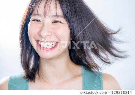 woman blowing her hair 129818814