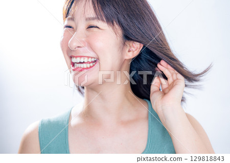 woman blowing her hair woman blowing her hair 129818843