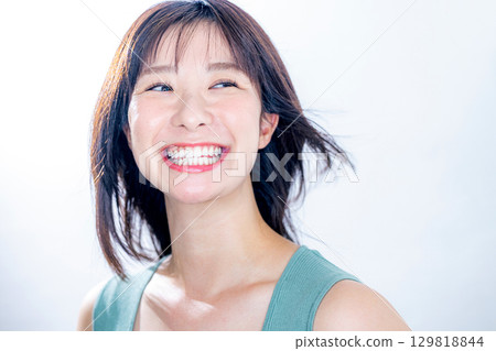 woman blowing her hair woman blowing her hair 129818844