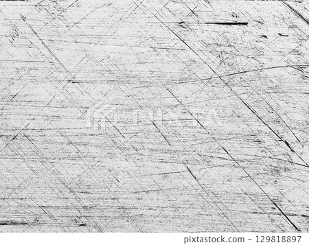 Scratched wooden surface showing texture and wear in a well-used workspace 129818897