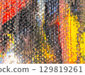 Vibrant abstract painting with dynamic colors and texture showcasing artistic expression in a gallery setting 129819261