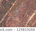 Close-up view of a textured surface showcasing earthy tones and intricate patterns found in natural materials 129819266