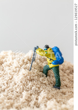 Tiny Explorer Figurine on Mountain Concept Tiny Explorer Figurine on Mountain Concept 129819527