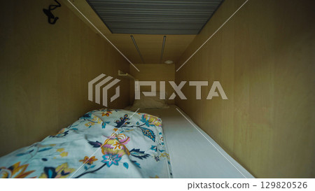 Cozy capsule hotel room inviting guests for comfortable rest Cozy capsule hotel room inviting guests for comfortable rest 129820526