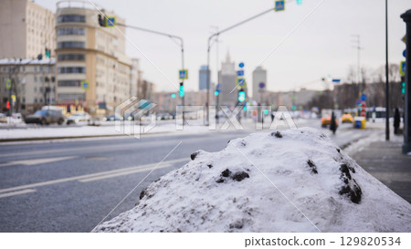 Snow pile by the roadside covering dirty frozen ground in Moscow winter Snow pile by the roadside covering dirty frozen ground in Moscow winter 129820534
