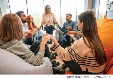 Holding hands. Group of people are having therapy meeting together 129820623