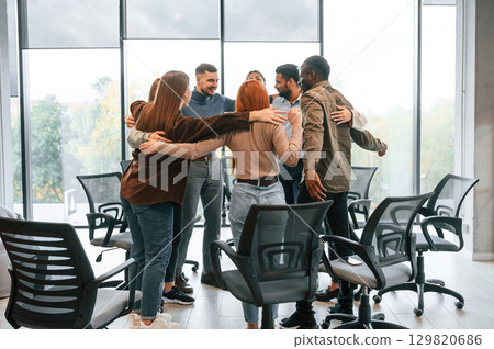 Embracing each other. Group of people are having therapy meeting together Embracing each other. Group of people are having therapy meeting together 129820686
