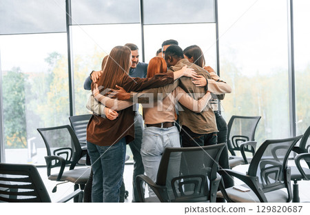 Embracing each other. Group of people are having therapy meeting together 129820687