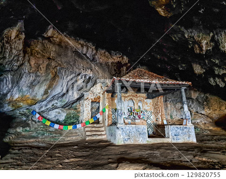 Dark interior of Lapa de Santa Margarida in Arrabida, Setubal, Portugal. Cave with small chapel of spontaneous worship 129820755
