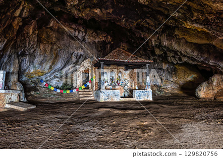 Dark interior of Lapa de Santa Margarida in Arrabida, Setubal, Portugal. Cave with small chapel of spontaneous worship Dark interior of Lapa de Santa Margarida in Arrabida, Setubal, Portugal. Cave with small chapel of spontaneous worship 129820756