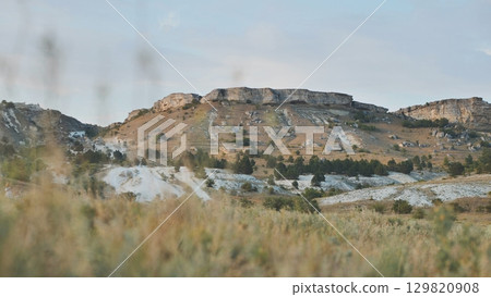 White Rock mountain landscape near Belogorsk, Crimea, showcasing dry grassland and coniferous trees 129820908
