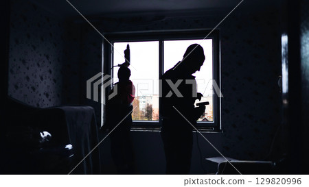 Construction workers installing window in apartment 129820996