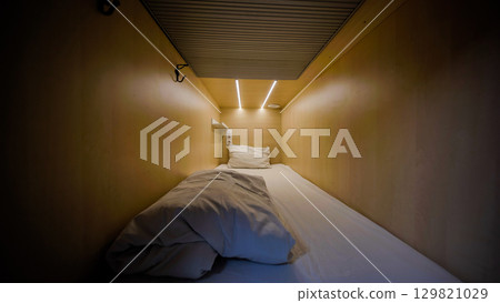 Capsule hotel room inviting guests for comfortable overnight stay Capsule hotel room inviting guests for comfortable overnight stay 129821029