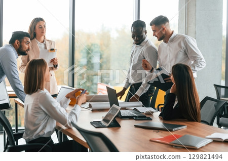 Team are busy and bringing the ideas for project. Group of office workers are together indoors 129821494
