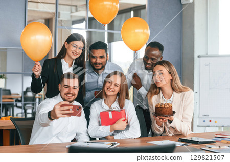 Employee having a birthday in the office, group of workers Employee having a birthday in the office, group of workers 129821507