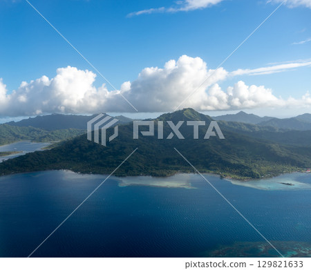 Aerial view of Tahaa island, French Polynesia, with turquoise lagoon and reef 129821633