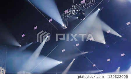 Professional lighting equipment illuminating stage with bright white beams during a concert or show 129822006