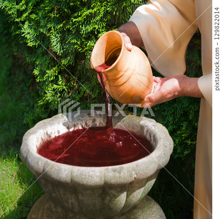 Hands pour water into the pot 129822014
