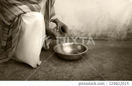 Man pour water into bowl 129822015