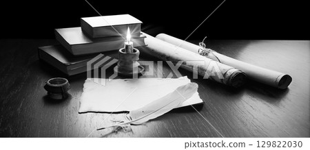 Books and candle on the table 129822030