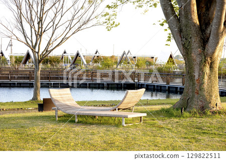 Lakeside at sunset Beach beds set up under the trees 129822511