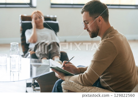 Life problems. Woman is sitting in chair at an appointment with a psychologist 129822560