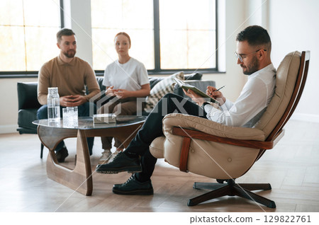 Sitting and talking. Couple at a psychologist's appointment Sitting and talking. Couple at a psychologist's appointment 129822761