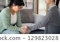 Psychologist or family holding hands to encourage patient with depression, mental health concept 129823028