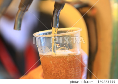 Beer poured from the tap, craft beer, draft beer 129823155