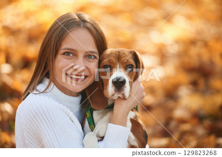 Close up portrait, embracing animal. Woman is with her cute dog in the autumn forest Close up portrait, embracing animal. Woman is with her cute dog in the autumn forest 129823268