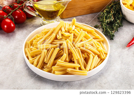 Raw dry Italian pasta - casarecce 129823396